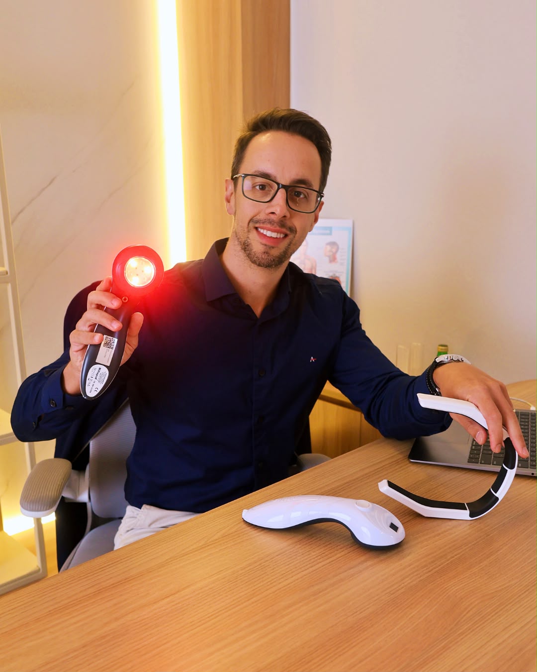 Diogo holding a red-light photobiomodulation device